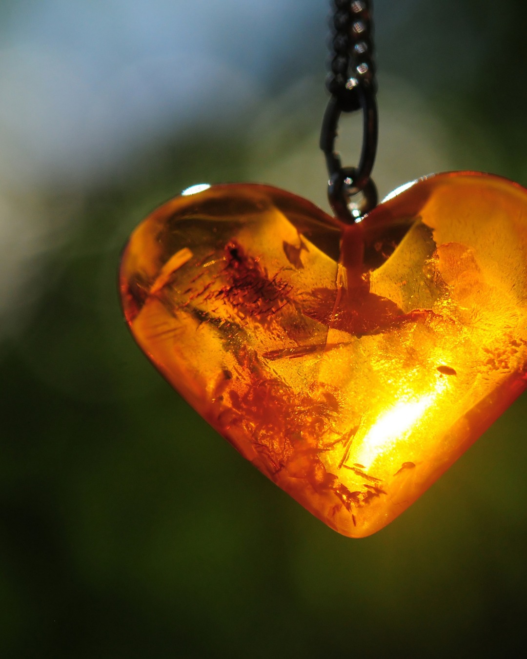 Amber heart pendant glowing in the light